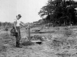 A GI points to detail at Japanese training ground in Rangoon, Burma, during WWII.