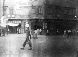 Street scene in China, with the Paramount Cafe in the background. During WWII.