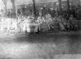 "Moving again."  GIs in transit through a train station in China during WWII. Notice the carbine in one GI's hands.