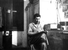 Fernand Arel, writing in the barracks, in with Daggett and Bates, Yangkai, China July 1944.