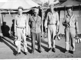 GIs pose with mess gear in front of tents in the CBI during WWII: Joey Barus, Archie Shiun, Joe Pruit, Ray Michell.