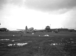 Base, planes, and control Tower at an American base in China during WWII. Local people in Yunnan province, China, most likely around the Luliang air base area.