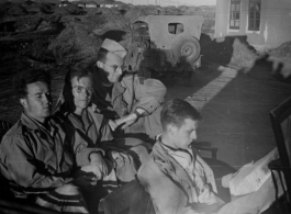 "Hale, Sigmier, Feldman  4th man unknown?" sitting on a jeep at a base in Yunnan province during WWII.