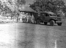 Bearers carry an American who has died from an ambulance to a temporary war-time graveyard. In the CBI, during WWII.