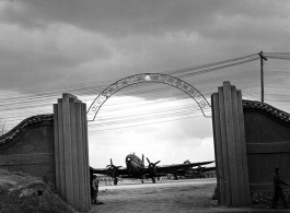 Guarded gates of the Nationalist Kunming Air Force Officer Training School during WWII, with C-46 transports.