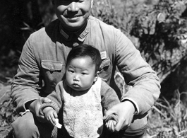 A Chinese Nationalist soldier, surname Li (李), and child in China during WWII. This was not a random family and Wozniak knew them, as another image in the collection show this image tacked to a wall in a home--a gift from Wozniak to the family.