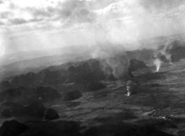 Smoke rises from probable American air attacks on Japanese ground troops, probably in Guangxi province, probably during the Japanese Ichigo campaign of 1944. 