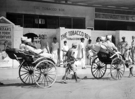 African-American GIs touring in India during WWII. "Rickshaws are almost as common in India as they are in China. Some of the...troops are on their way to see `Tarzan's New York Adventure'---in India..."