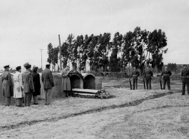 Chaplain Dwayne H. Mengel conducts a temporary military burial in Yunnan, China.  The 308th took heavy casualties, and one of the Chaplain's duties included burying recovered bodies in local graves until they could be repatriated after the war.