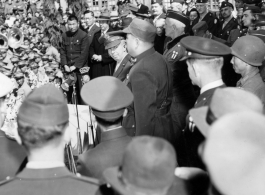 Burma Road dedication parade and ceremony in Kunming, China, on or around February 4, 1945, during WWII. Review of first convoy (or one of the first convoys) to reach China. Chinese and American military officers give speeches into microphones.