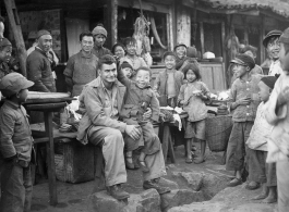 At a hardware stand, GI Fred Nash, with appreciative local people. Yangkai Village, Spring 1945.