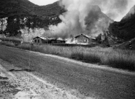 American hostels at the base burn during the American and Chinese retreat before the Japanese arrive during the Ichigo push in the fall of 1944.  Guangxi province, Liuzhou air base.