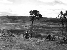 An American serviceman walking  on the hill above Yangkai air base, in Yunnan province, China, during WWII. Note the carbine rifle he carries for protection.