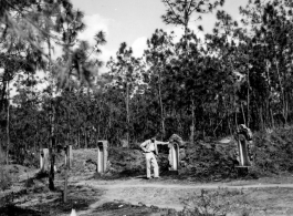 GI explorations of the hostel area at Yangkai air base during WWII: A GI looks at local graves.