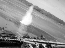 Bombing of small rail bridge, among a flood plain, in French Indochina during WWII.