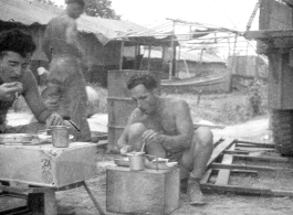 GIs getting chow while on the road or at a camp. During WWII in the CBI.