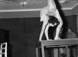 Celebrities visit and perform at Yangkai, Yunnan province, during WWII: Betty Yeaton performs contortionist act.