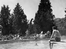 GIs do poolside R&R, during WWII, at hilltop rest house or manor house. In India? Ceylon? Note round crenelated tower in the background.
