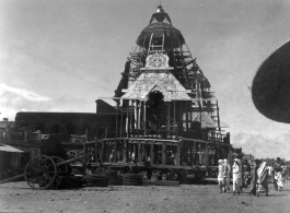 Enormous floats for a religious parade being assembled. Probably for the the Rath Yatra celebration at the large Jagannath Temple of Odisha complex (Hindu) in India.  Scenes in India witnessed by American GIs during WWII. For many Americans of that era, with their limited experience traveling, the everyday sights and sounds overseas were new, intriguing, and photo worthy.