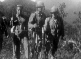 American GIs (and possibly Chinese soldier or interpreter) on mountains near Baoshan, Yunnan, China, during WWII, during battle with Japanese forces.