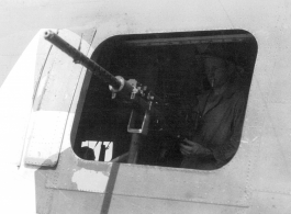 Gunner at waist gun of B-24 in the CBI during WWII.