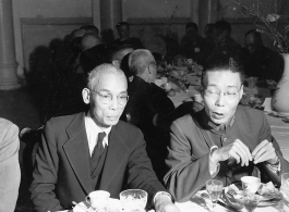 Eating banquet dinner at party at Governor Lung's of Yunnan Province on December 16, 1944. Secretary Liang Yu-kao, and Gen. Liu Ya-yang.  Photo by Pfc. Thomas F. Melvin.  Passed by censor William E. Whitten.