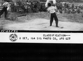 Chinese acrobatic group puts on show for Burma Road Engineers (BRE) members at the air strip, at Tengchong, China.  December 8, 1944.  Photo by T/Sgt. Greenberg. 164th Signal Photographic Company, APO 627.  Passed by William E. Whitten.