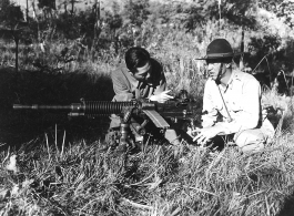 Capt. O. D. Propps, American Liaison Officer, and Col. Tung Tau, commanding 388 Regiment, 130th Division, 53rd Chinese Army, inspect captured Japanese heavy machine gun, captured on Li La Hill northwest of Chefang. This machine gun fires 7.92 mm ammunition.  Yunnan Province on November 28, 1944.   Photo by T/5 W. E. Shemorry. B-Detachment, 164th Signal Photographic Company, APO 627.  Passed by William E. Whitten.