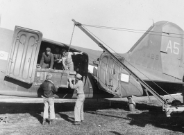 Unloadeding AAC equipment from C-47 at Tengchong airstrip.  December 14, 1944.  Photo by T/Sgt. S. L. Greenberg. 164th Signal Photographic Company, APO 627.  Passed by William E. Whitten.