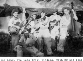 String band "Ledo Trail Winders" in the CBI during WWII, with MC and leader Horace Jones seated on the ground.