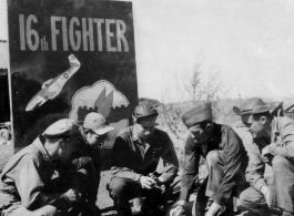 American flyers of the 16th Fighter Squadron in China, before a sign at Chenggong. Stanley Mamlock in center of group.  In Chinese the sign says "Great Wall In The Air" ("空中長城").  During WWII.