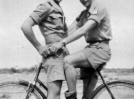 Two flyers goof on a bicycle in the CBI during WWII. Stanley Mamlock on the right.