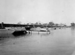 797th Engineer Forestry Company in Burma: Enormous floating bridge over a river on the Burma Road.  During WWII.