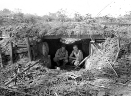 Engineers of the 797th Engineer Forestry Company pose in an old bunker, either American or Japanese.  During WWII.