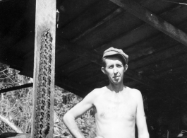 Engineer of the 797th Engineer Forestry Company poses with sharp chain from chainsaw in Burma.  During WWII.
