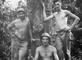 Engineers of the 797th Engineer Forestry Company pose against tree in Burma.  During WWII.