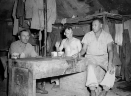 Engineers of the 797th Engineer Forestry Company pose in their tent in Burma, with checker pieces.  During WWII.