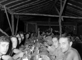 Engineers of the 797th Engineer Forestry Company eating meal at camp in Burma.  During WWII.