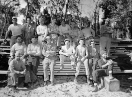 Engineers of the 797th Engineer Forestry Company pose outside on stack of sawn lumber at a camp in Burma.  During WWII.