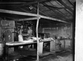 GIs working in a kitchen in a camp in Burma.  During WWII.  797th Engineer Forestry Company.