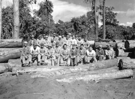 Engineers of the 797th Engineer Forestry Company pose on logs in Burma.  During WWII.