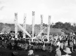 Kachin people dancing the manau dance, at the center of a Kachin community.  In Burma near the 797th Engineer Forestry Company.  During WWII.