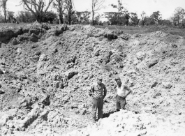GIs examine giant bomb crater in Burma.  During WWII.  797th Engineer Forestry Company.