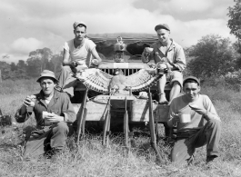 Engineers of the 797th Engineer Forestry Company pose with their catch after a round of huntin' bird in Burma.  During WWII.
