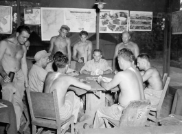 Engineers of the 797th Engineer Forestry Company playing cards at camp in Burma.  During WWII.
