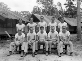 Engineers of the 797th Engineer Forestry Company pose outside tents with basketball gear in Burma.  During WWII.