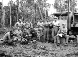 Engineers of the 797th Engineer Forestry Company pose at work site eating sandwiches, in Burma.  During WWII.