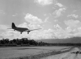 A C-47 transport taking off from an airstrip in Burma.  Aircraft in Burma near the 797th Engineer Forestry Company.  During WWII.