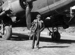 Photographer Edward Harold Dixon standing before a C-47 at a base in China, during WWII.