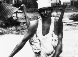 A contortionist and a snake charmer in India during WWII.